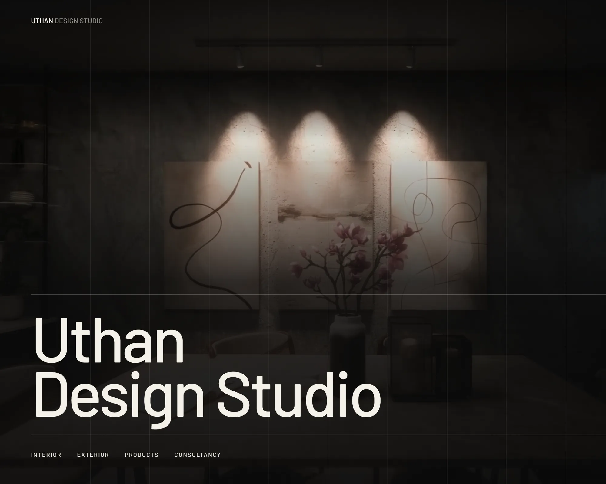 The home page of the Uthan Design Studio website: the studio's name in large type over a dim interior lit by three spotlights, with its four areas of work listed below.